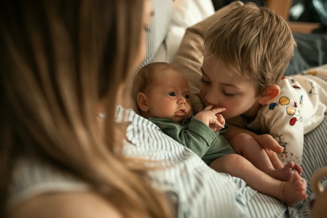 Mother with her newborn and toddler, a tender family moment