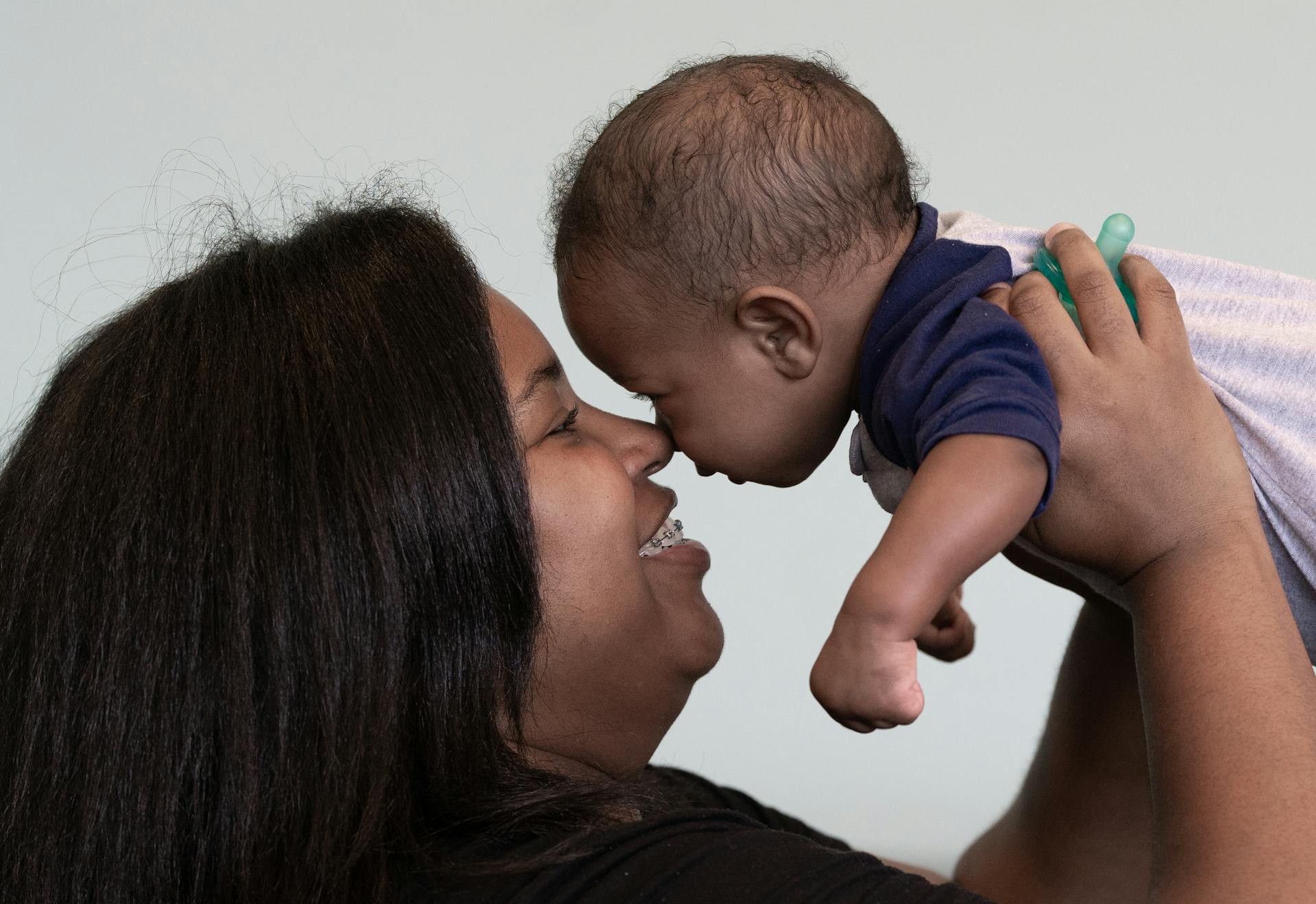 Black mother sharing a loving nose-to-nose moment with her newborn baby